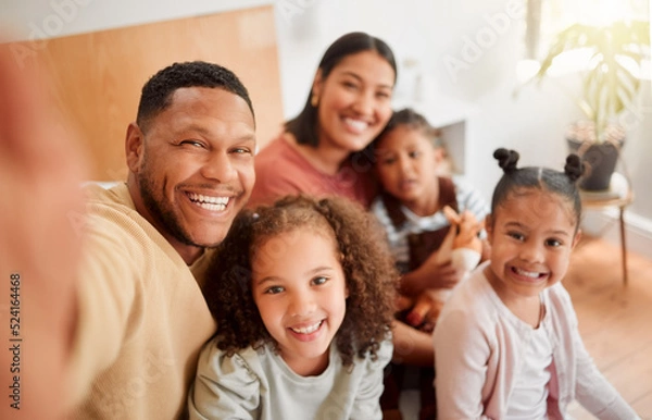 Fototapeta Happy family taking selfie, having fun, relaxing and bonding in living room at home. Smiling, carefree parents enjoying time with children indoors, being affectionate and together on the weekend