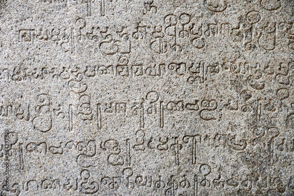 Fototapeta Inscriptions of ancient language carved on the stone walls at Hindu temple in Mahabalipuram, Tamilnadu, India. Ancient tamil inscriptions carved in the exterior temple walls in Mahabalipuram.