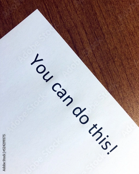Fototapeta "You Can Do This" inspirational quote on paper sitting on a wood desk surface.