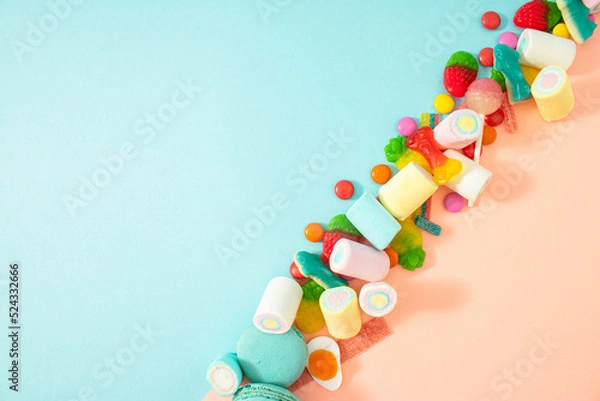 Obraz Creative Halloween.concept many sweets for children in one place, a delicious junk snack. Flat lay, pastel blue background.