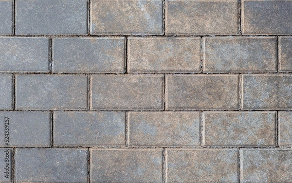 Fototapeta Grey brick wall background close up. Gray stone tile block background with horizontal texture of gray brick. Gray brick surface