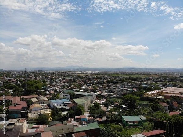 Obraz Aerial shot of residential areas in Philippines overlooking a mountain