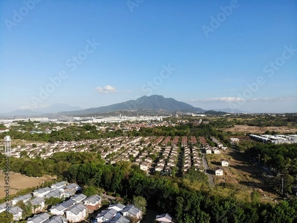 Obraz Aerial shot of residential areas in Philippines overlooking a mountain