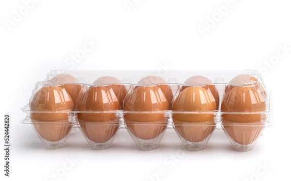 Fototapeta Eggs in a plastic box on the white background