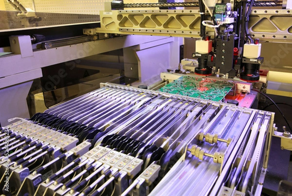 Fototapeta Installer of SMD parts on boards and soldering parts. Machine for automatic assembly and soldering of electronic circuit boards. Electrical soldering parts. 