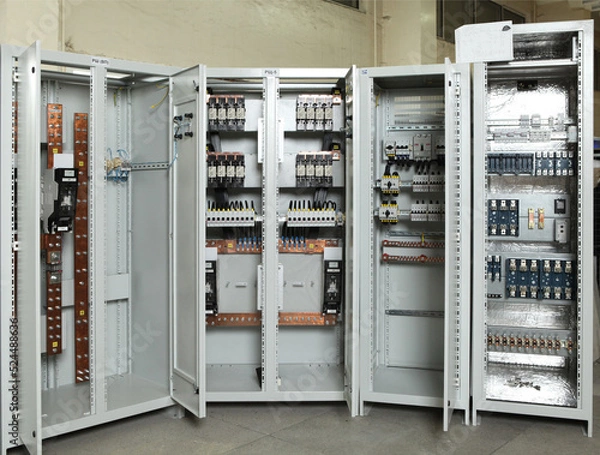 Fototapeta Electrician engineer work tester measuring voltage and current of power electric line in electical cabinet control.and wires on relay protection system. Bay control unit. Medium voltage switchgear.