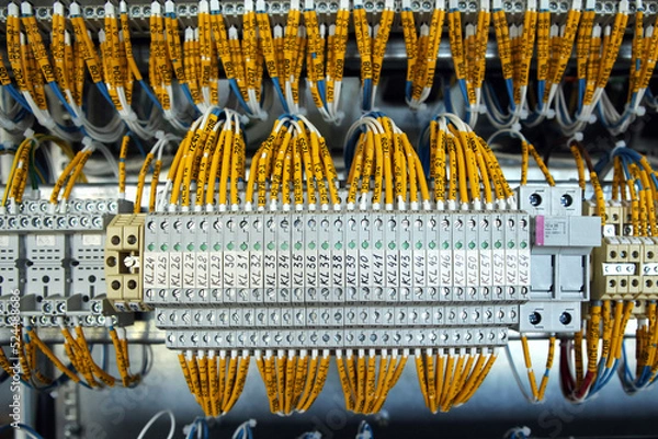Fototapeta Electrician engineer work tester measuring voltage and current of power electric line in electical cabinet control.and wires on relay protection system. Bay control unit. Medium voltage switchgear.