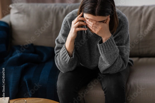 Fototapeta mental health, psychological help and depression concept - close up of stressed woman calling on phone at home