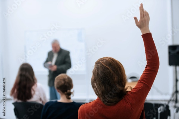 Fototapeta A famous professor has arrived at the university to conduct a special lesson, the student pulls his hand up to ask him a question