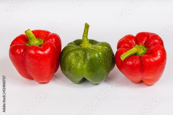 Obraz Two red green sweet peppers on a white background
