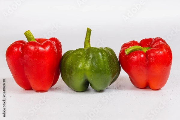Obraz Two red green sweet peppers on a white background