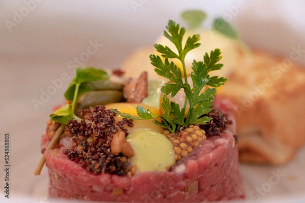 Fototapeta Salmon tartare with pepper and raw yolk