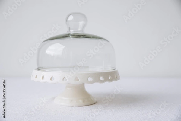 Fototapeta A cake stand on a covered white table, mock up