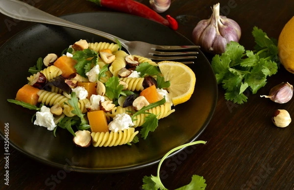 Obraz Pasta with baked pumpkin, feta, herbs and hazelnuts