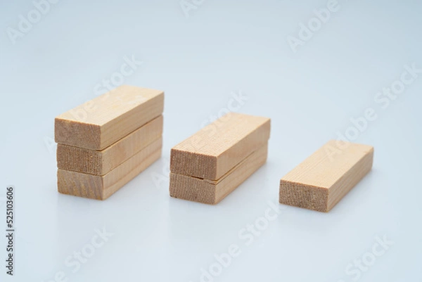 Fototapeta Expressing various concepts such as dominoes and business using wood jenga