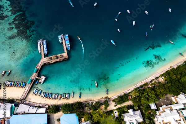 Fototapeta Aerial photo of Koh phi phi island in thailand with turquoise sea along with village and harbor