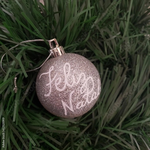 Obraz Christmas ball decorated with words. Merry Christmas. Feliz Natal. 
