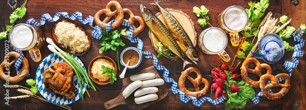 Fototapeta Festive served table with Bavarian specialities. Oktoberfest menu