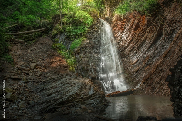 Fototapeta beautiful landscape with a small waterfall in a forest with stone terrain