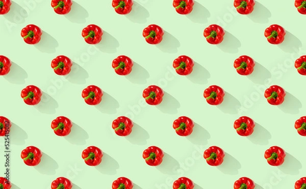 Fototapeta Pattern of red peppers on green pastel background