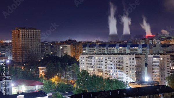 Fototapeta Industrial factory in the modern city. Power plant chimneys. Environment pollution problems