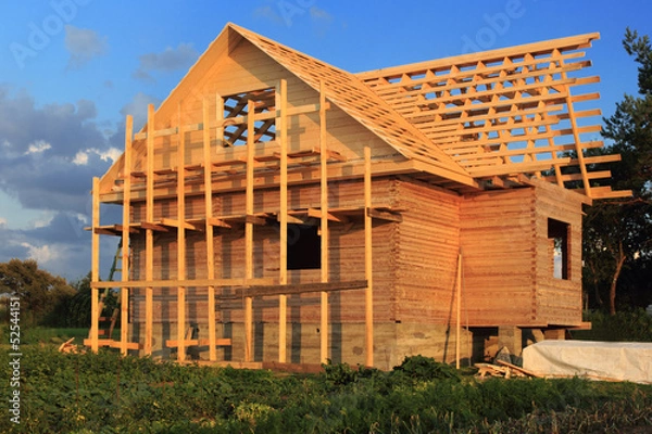 Fototapeta Wooden house in scaffolding under construction