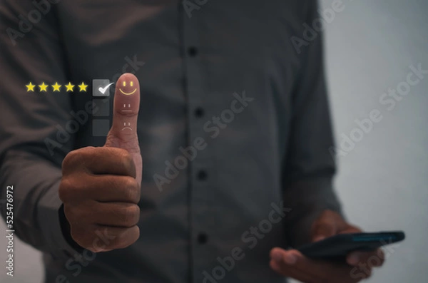 Fototapeta Customer satisfaction concept. thumb up Positive emotion smile face and five star with copy space, feedback, service, survey, standard quality. User give rating to service experience, certification.