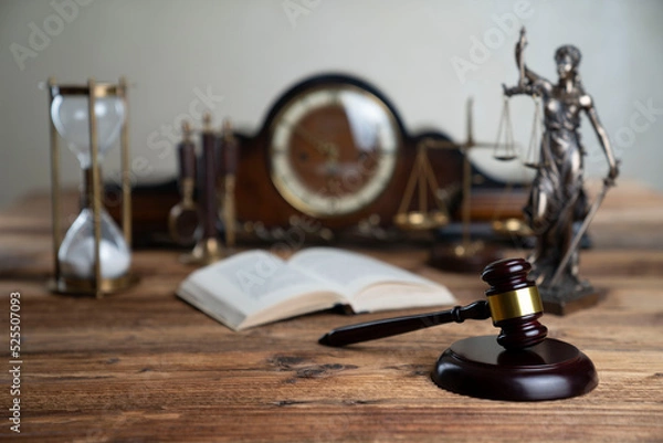 Fototapeta Law concept. Law symbols composition: judge’s gavel, Themis sculpture and scale on rustic wooden desk.