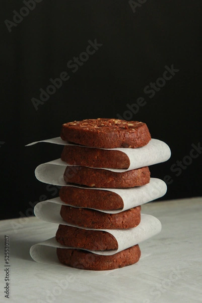Obraz Pile of Chocolate Cookies on dark black background on a table.