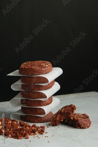 Obraz Pile of Chocolate Cookies on dark black background on a table.