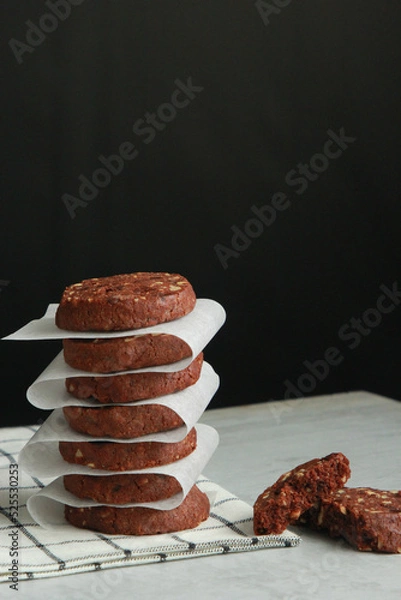 Obraz Pile of Chocolate Cookies on dark black background on a table.