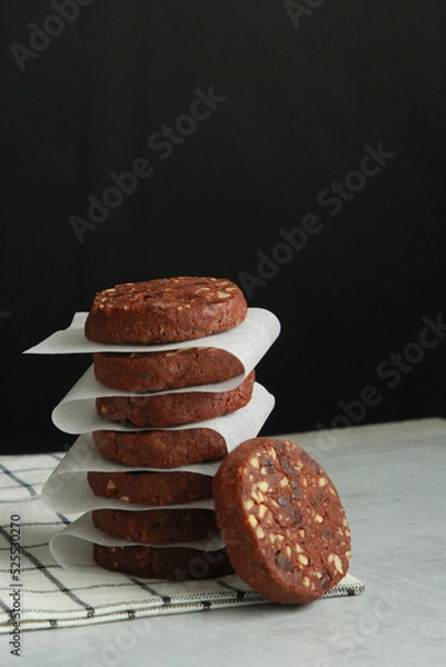 Obraz Pile of Chocolate Cookies on dark black background on a table.