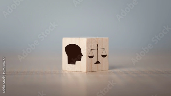 Fototapeta Ethics inside human mind, Business ethics concept. Hand flip ethics inside a head symbols in wooden cubes on dark background with copy space..