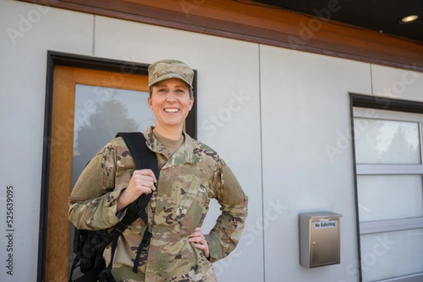 Fototapeta Air Force service member gets ready for work and leaves.