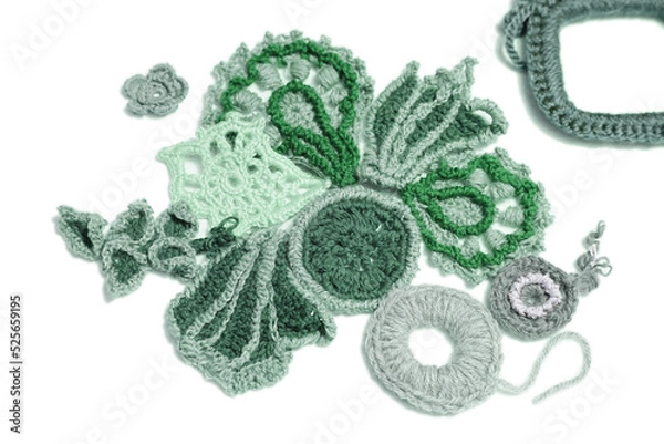 Fototapeta Lots of knitted flowers and foliage on a white background. Idea for a needlework website