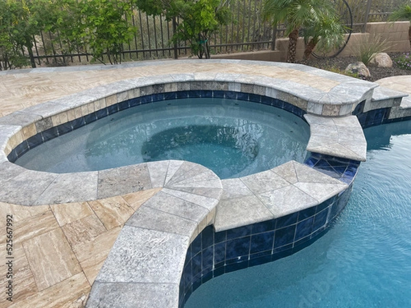 Fototapeta A travertine tile spa and pool remodel.