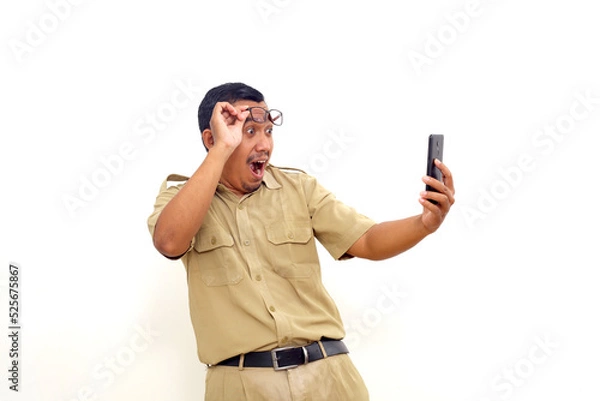 Fototapeta Wow and amazed expression of Indonesian government employees while holding cell phone.