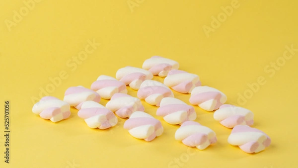 Fototapeta Marshmallows on a yellow background in the form of a triangle