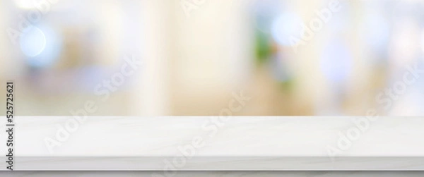 Obraz Empty white table top, counter, desk over blur perspective store with bokeh light background, White marble stone table, shelf and blurred shop for food, product display mockup, template