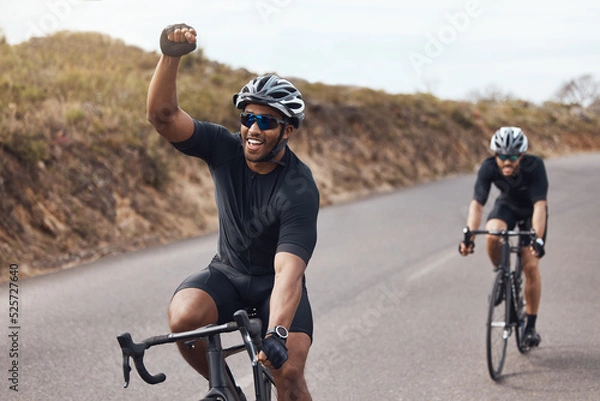 Obraz Winner, celebrating and winning cyclist cycling with his friend and racing outdoors in nature. Victory, joy and happy bicycle rider exercising on a bike for his workout routine on the road