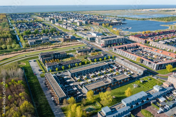 Obraz Modern green neighbourhood in Almere, The Netherlands, surrounded by water and nature, city built on reclaimed land (Flevoland polder). Aerial view.