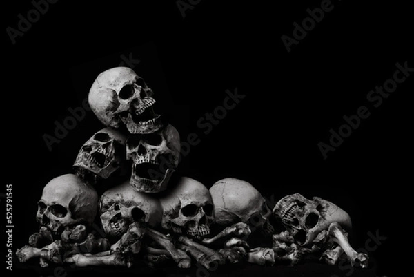 Fototapeta Awesome pile of skull human and bone on wooden, black cloth background, concept of scary crime scene of horror or thriller movies,Halloween theme, Still Life style, selective focus,