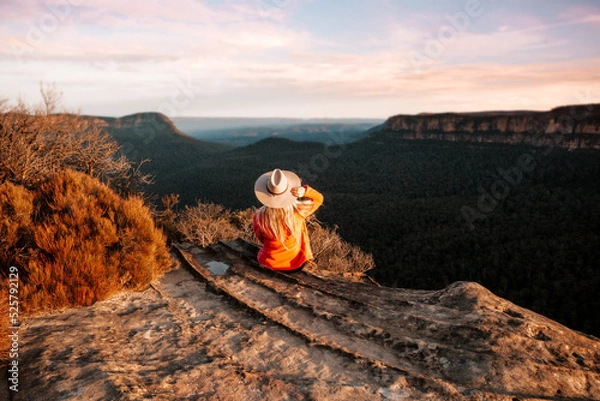 Obraz Woman looks out over the mountains in the late afternoon sun