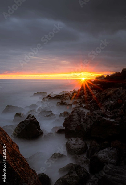 Obraz Long exposure waves hitting the coast of Madeira at Ponta do Sol during a summer sunset