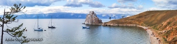 Fototapeta Baikal Lake in August. Panoramic view of famous Shamanka Rock on Olkhon Island - a place of attraction for tourists traveling on sailing yachts on the water and beach lovers. Summer travaling concept