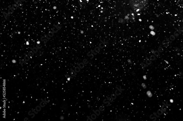 Obraz falling snow out of focus, isolated on a black background