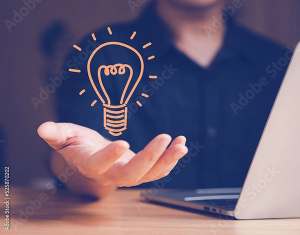 Fototapeta Idea of ​​inspiration online technology and innovation idea concept. Hand hold light bulb for getting good idea.