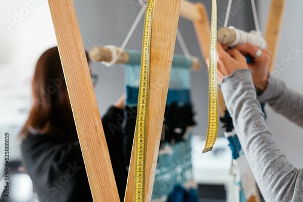 Fototapeta Close up of woman's hands making macrame