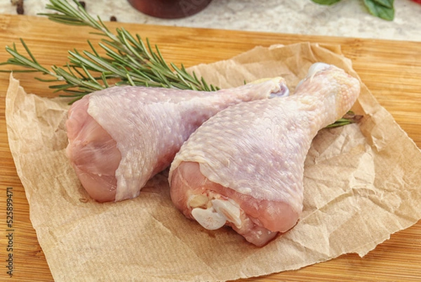 Obraz Raw chicken leg over board