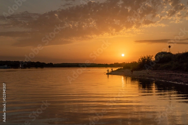 Fototapeta Beautiful bright dramatic sunset over the river
